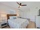 Bright bedroom with a ceiling fan, a woven headboard and a full size bed and bedside tables at 125 11Th Ave, Indian Rocks Beach, FL 33785