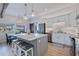 Modern kitchen features an island with seating, stainless steel appliances, and stylish pendant lighting at 125 11Th Ave, Indian Rocks Beach, FL 33785