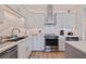 Modern kitchen featuring stainless steel appliances, white cabinets, and quartz countertops at 125 11Th Ave, Indian Rocks Beach, FL 33785