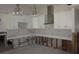 Kitchen with white cabinets, modern pendant lights, and exposed studs at 125 11Th Ave, Indian Rocks Beach, FL 33785