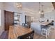 Open kitchen with white cabinets, stainless steel appliances, an island with seating and a view of dining area at 125 11Th Ave, Indian Rocks Beach, FL 33785