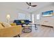 Cozy living room with a beach view on the television and warm natural light at 125 11Th Ave, Indian Rocks Beach, FL 33785