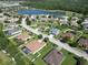 Aerial shot showcasing a community with lush landscaping, surrounding lakes, and mature trees at 12903 49Th E Ln, Parrish, FL 34219