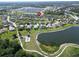 Aerial view pinpoints a home within a community featuring a lake, trails, and a tennis court at 12903 49Th E Ln, Parrish, FL 34219