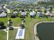 Aerial perspective of homes neighboring a lake, walking path, and tennis courts, with lush landscaping at 12903 49Th E Ln, Parrish, FL 34219
