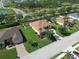 Aerial view displaying the property's lush lawn and prime positioning within the neighborhood at 12903 49Th E Ln, Parrish, FL 34219