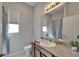 Bathroom featuring granite countertop, large mirror, and shower at 12903 49Th E Ln, Parrish, FL 34219