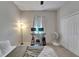 Neutral bedroom featuring a ceiling fan, comfortable bed, a desk, and a bright window at 12903 49Th E Ln, Parrish, FL 34219