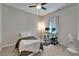 Neutral bedroom with a ceiling fan, comfortable bed, and desk area with dual monitors at 12903 49Th E Ln, Parrish, FL 34219