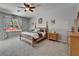 Calm primary bedroom with a four-poster bed, ceiling fan, and natural light at 12903 49Th E Ln, Parrish, FL 34219