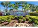 Attractive community sign with stone accents, landscaping, and palm trees in Gamble Creek Estates at 12903 49Th E Ln, Parrish, FL 34219