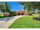 Traditional home featuring a well-kept lawn, arched windows, columned front door, and a two car garage at 12903 49Th E Ln, Parrish, FL 34219