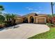 Stunning single-story home with a well-manicured lawn, mature trees, and a circular driveway at 12903 49Th E Ln, Parrish, FL 34219