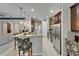 Modern kitchen featuring stainless steel appliances, wood cabinets, and decorative pendant lighting at 12903 49Th E Ln, Parrish, FL 34219