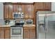 Well-equipped kitchen with stainless steel oven and refrigerator at 12903 49Th E Ln, Parrish, FL 34219