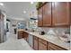 Kitchen featuring stone countertops, stainless steel appliances and dark wood cabinetry at 12903 49Th E Ln, Parrish, FL 34219