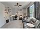 Inviting living room with ceiling fan, comfortable leather sofa, desk, and large window at 12903 49Th E Ln, Parrish, FL 34219
