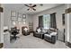 Comfortable living room with a ceiling fan, leather reclining sofas, desk, and gray walls at 12903 49Th E Ln, Parrish, FL 34219