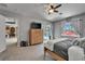 Spacious main bedroom featuring a TV, ceiling fan, adjacent view of pool, and access to more rooms at 12903 49Th E Ln, Parrish, FL 34219