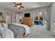 Inviting primary bedroom boasts a large window, a flatscreen TV, and pool view at 12903 49Th E Ln, Parrish, FL 34219