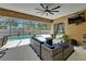 A screened-in lanai boasts ample seating, string lights, and access to a private pool at 12903 49Th E Ln, Parrish, FL 34219