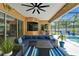 Outdoor living featuring a screened-in patio with seating, a ceiling fan, and a pool view at 12903 49Th E Ln, Parrish, FL 34219