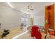 Bright bedroom featuring carpeted floors, a ceiling fan, and natural light from a large window at 13750 Dowling Ln, Odessa, FL 33556
