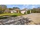 Residential house with spacious driveway, grassy lawn, and mature trees at 13750 Dowling Ln, Odessa, FL 33556