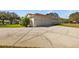 Three car garage with a wide concrete driveway and well-kept lawn at 13750 Dowling Ln, Odessa, FL 33556