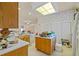 Bright eat-in kitchen with tiled floors, an island, and plentiful cabinetry for storage at 13750 Dowling Ln, Odessa, FL 33556