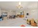 Spacious living area featuring tile floors, a ceiling fan, and sliding glass doors at 13750 Dowling Ln, Odessa, FL 33556