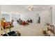 Large living room with tile flooring, double doors, and ceiling fan at 13750 Dowling Ln, Odessa, FL 33556