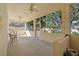 Covered and screened-in patio with ceiling fans and outdoor view at 13750 Dowling Ln, Odessa, FL 33556