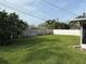 Well-maintained backyard with healthy green grass and a wooden fence creating a private outdoor space at 14264 Page Ave, Largo, FL 33774