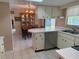 Well-appointed kitchen with white cabinets, stainless steel appliances, and a view of the dining area at 14264 Page Ave, Largo, FL 33774
