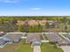 Aerial view of a home with a fenced backyard and surrounding greenery and neighboring properties at 16302 Vine Cliff Ave, Hudson, FL 34667
