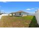 Fenced backyard offering a private outdoor space with lawn and views of the home at 16302 Vine Cliff Ave, Hudson, FL 34667