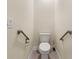 Powder room featuring a toilet and supportive safety bars for accessibility at 16302 Vine Cliff Ave, Hudson, FL 34667