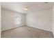 Neutral bedroom offers plush carpeting, a window with blinds, and a well-lit, comfortable space at 16302 Vine Cliff Ave, Hudson, FL 34667