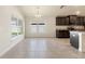 Bright dining area with a view of kitchen and backyard, and dark wood cabinetry at 16302 Vine Cliff Ave, Hudson, FL 34667