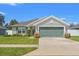Charming single-story home featuring a well-manicured lawn and a two-car garage at 16302 Vine Cliff Ave, Hudson, FL 34667
