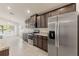 Bright kitchen boasts stainless steel appliances, generous cabinetry, and stone countertops at 16302 Vine Cliff Ave, Hudson, FL 34667