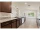 Open kitchen features an island with stainless steel sink, ample counter space, and modern appliances at 16302 Vine Cliff Ave, Hudson, FL 34667