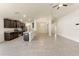 Open-concept living room features modern lighting, neutral color palette, and seamless flow into kitchen area at 16302 Vine Cliff Ave, Hudson, FL 34667