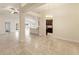 Open-concept living space with tile flooring, dining area, and view to kitchen at 16302 Vine Cliff Ave, Hudson, FL 34667