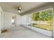 Screened patio with a ceiling fan offering a relaxing outdoor space with views of the yard and white picket fence at 16302 Vine Cliff Ave, Hudson, FL 34667