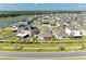An aerial view shows a single-story home with a manicured backyard in a residential community at 16934 Oval Rum Dr, Wimauma, FL 33598