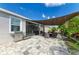 Backyard with pavers, grill, and covered seating area, perfect for outdoor dining and entertaining at 16934 Oval Rum Dr, Wimauma, FL 33598