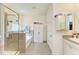 Bathroom with shower, separate tub, granite countertops, and a built-in linen closet at 16934 Oval Rum Dr, Wimauma, FL 33598