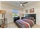 Cozy bedroom featuring a comfortable bed, dresser, and ceiling fan at 16934 Oval Rum Dr, Wimauma, FL 33598